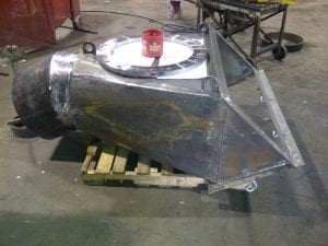 Rectangular to round transition chute for a pugmill discharge